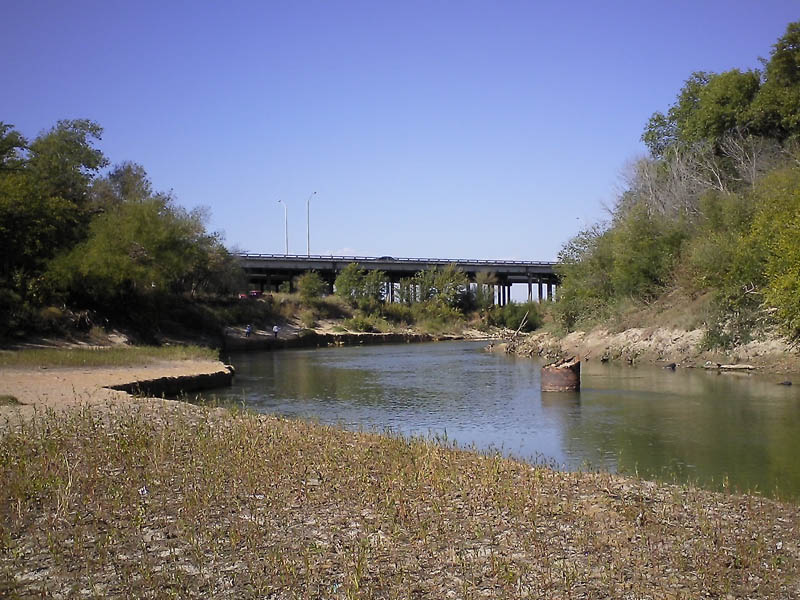 This location is the site of Miller Ferry.  This site was important all throughout the second half of the 1800's.  Notice the fishermen in the background.  That's the South Central Expressway bridge in the distance.