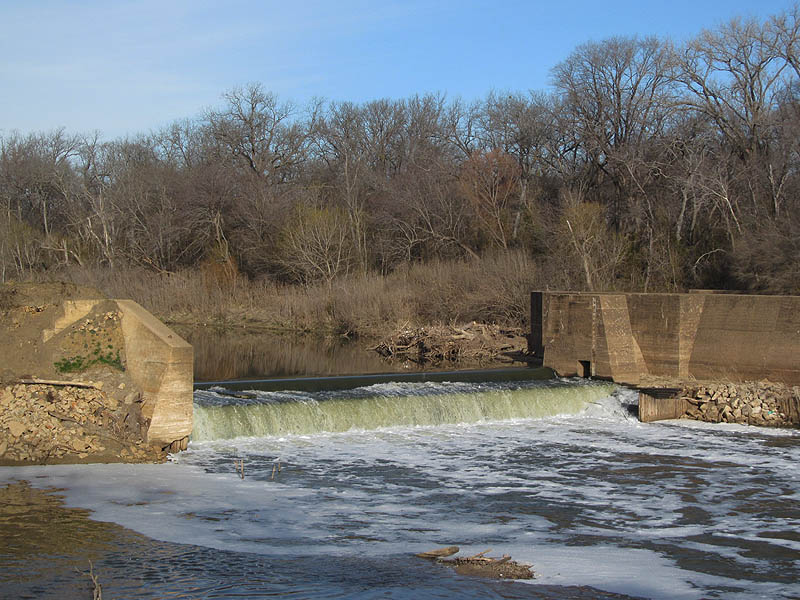 The dam creates a small waterfall on the Trinity River.