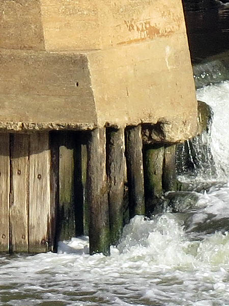 Wooden poles appear to be supporting the concrete at the south end of the lock.
