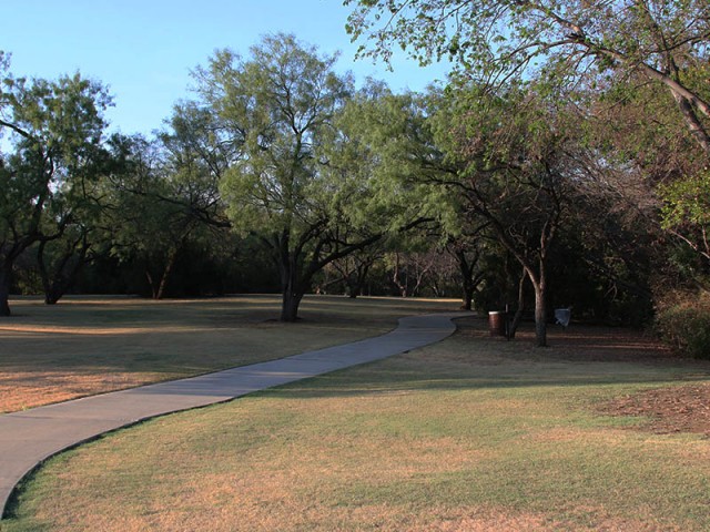 A tree-lined trail running along the park's west side.